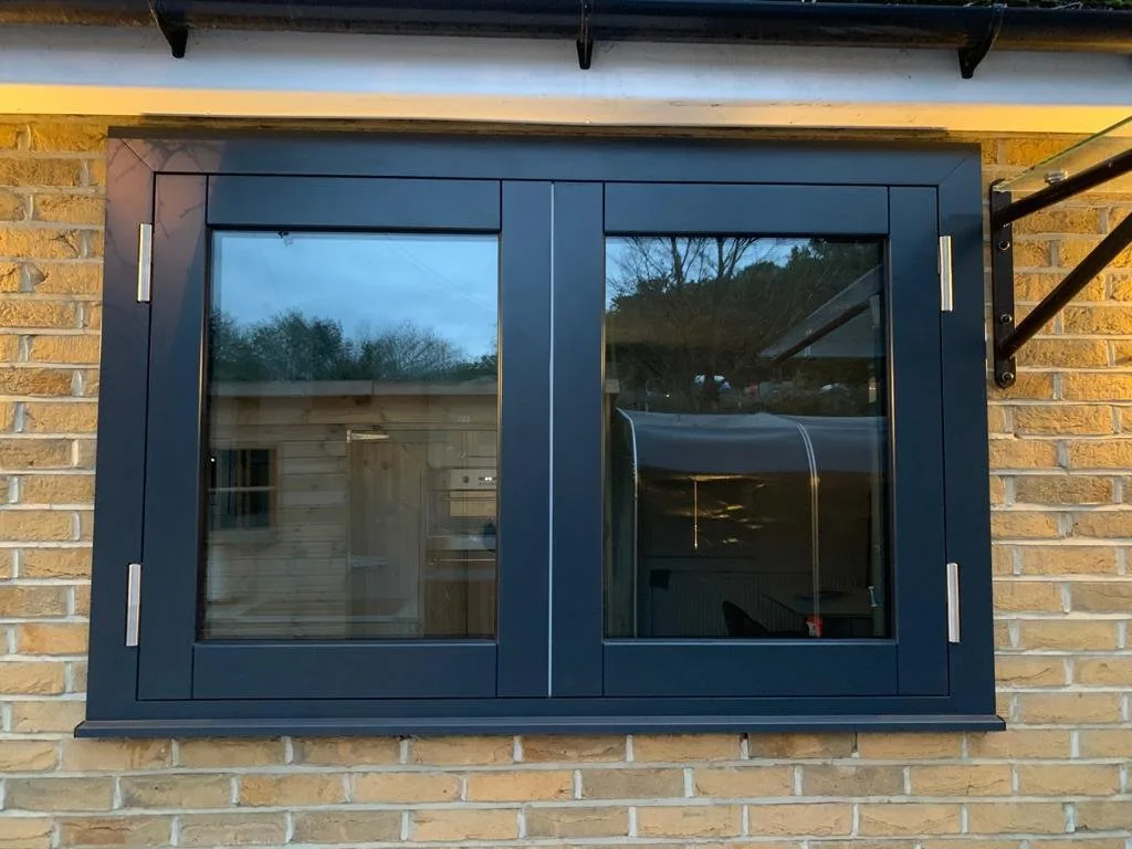 Casement-style security window with side-hinged sash and steel frame, fitted to a traditional UK property