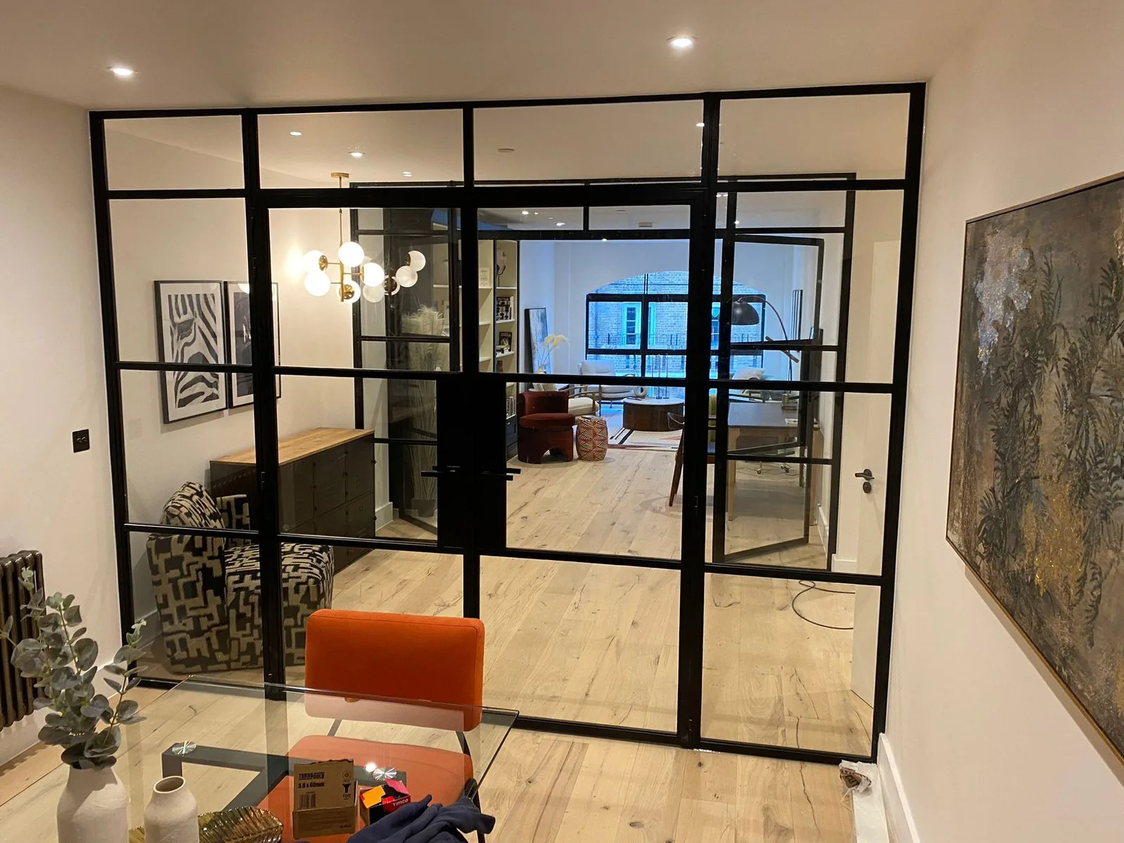Slim line steel doors separating interior living spaces