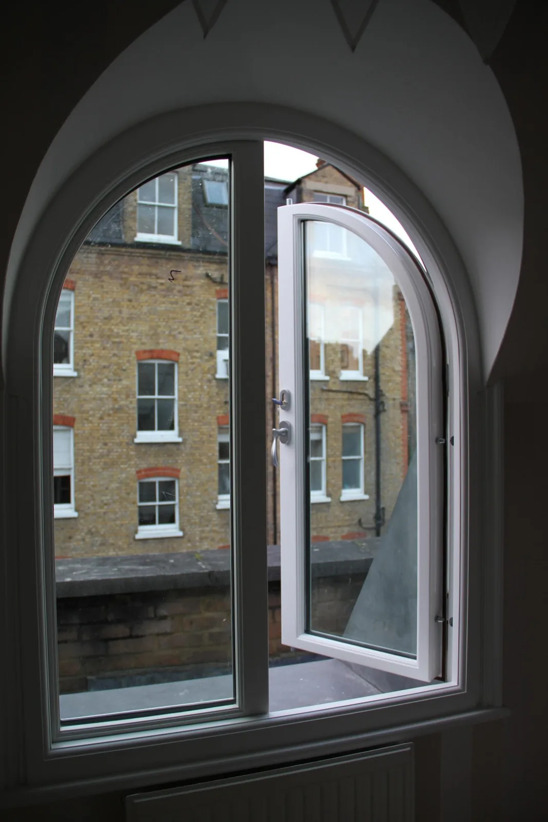 Arched-top security window fitted into a curved opening, period London property