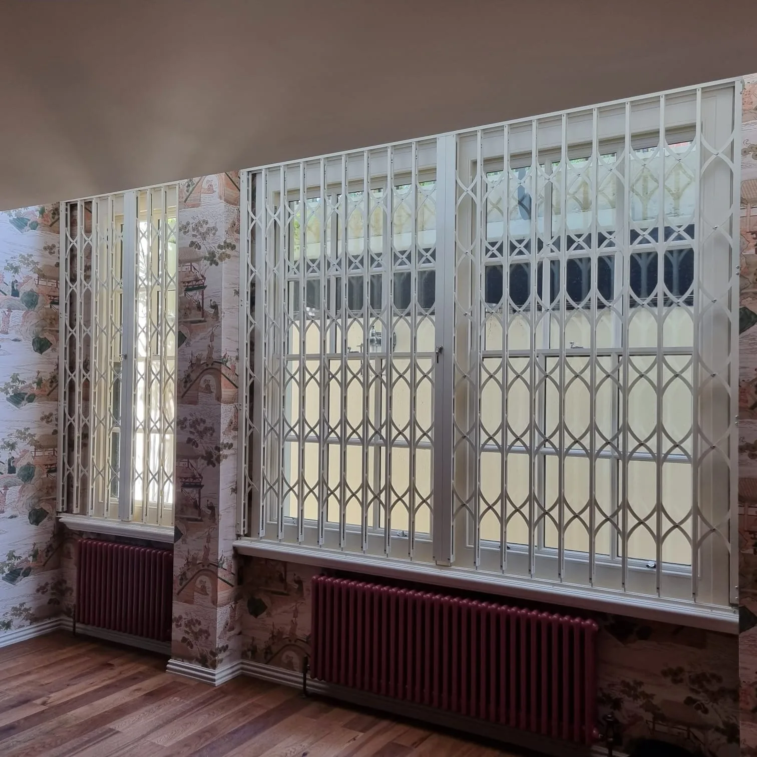Collapsible security grilles installed on residential windows
